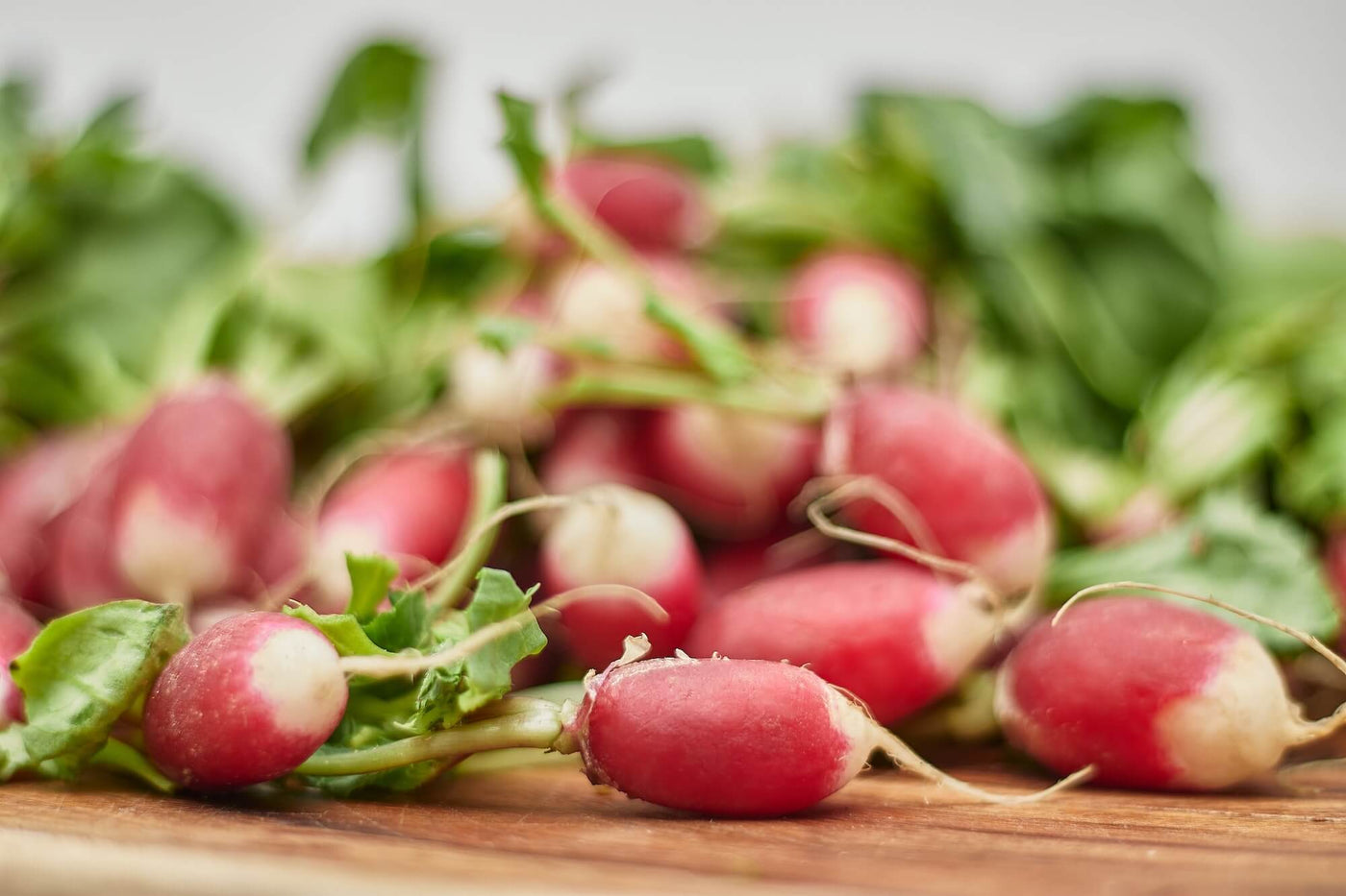 Radish seeds grown to radishes on a wooden table